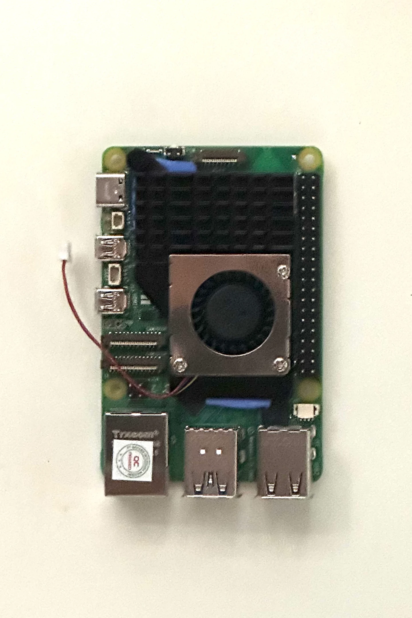 The Raspberry Pi 5 with a black heatsink and fan fitted